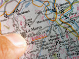 Finger on Map of Italy Pointing to Barolo  Near Alba  Italy