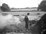 A Farmer Holding a Shovel on a Farm in England  1938