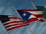 American  Puerto Rican and Italian Flags Waving against a Blue Sky