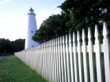 The Lighthouse Stands Behind a Fence on Ocracoke Island