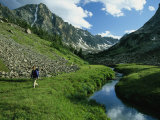 Hiker along a Stream in a Beartooth Mountains Valley