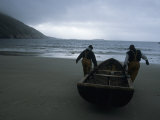 Commercial Salmon Fishermen Carry Their Boat Out to Check Their Nets