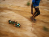 Child Pulling his Toy Truck at High Speed