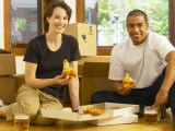 Couple Having Beer and Pizza in Empty Apartment