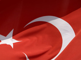 Close-up of the Flag of Turkey with a White Star and Moon on Red Fabric