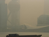 Barge Plies the Water in Front of Shanghais Pudong Area