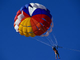 Person Parasailing in Sky off the Beach  Indonesia