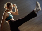 Side Profile of a Young Woman Kickboxing