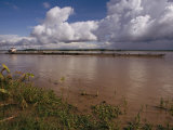 A Barge Moving up a Muddy Waterway