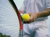 Man Holding a Tennis Ball And a Tennis Racket