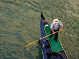 A Gondolier Steers His Craft Through a Canal  Venice  Veneto  Italy