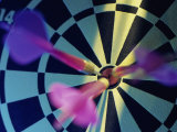 Close-up of Three Darts in the Bull's-Eye of a Dartboard