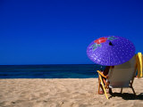 A Girl on the Beach Shading Under a Colourful Umbrella  Waikiki  Oahu  Hawaii  USA