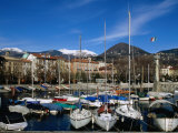 Yachts in Harbour at Intra with Old Town and Mountains in Background  Lago Maggiore  Italy