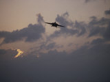 A Jet Comes in for a Landing on an Aircraft Carrier at Twilight