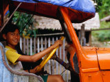 Boy Pretending to Drive Truck in Mrauk-U Village  Looking at Camera  Mrauk U  Myanmar (Burma)