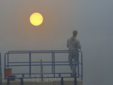 Early Morning Fisherman in Fog and Sunrise