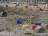 A Childs Colorful Toys are Scattered Throughout a Sand Box