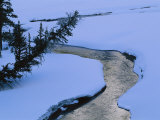 A Twilight View of Baronette Creek Winding Through a Snowy Landscape