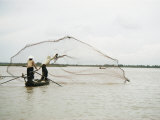 Fishermen Cast out a Net into the Mekong River