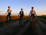 A Family  Dressed in Period Attire  Ride Old-Fashioned Bicycles Dating from the Late 1800s