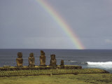 A Rainbow Arches Above Statues Carved from Volcanic Rock
