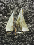 A Sailboat Floats on its Side after Being Capsized by a Gust of Wind