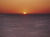 A Brillant Orange Sun Dips Behind the Mediterranean Sea