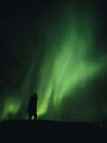 A Brilliant Display of Aurorae with a Persons Silhouette in the Image