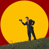 Businessman in Field Yelling into Megaphone