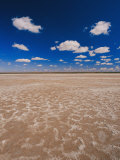 A Vivid Blue Sky Above Sand and Shallow Water
