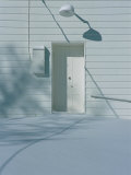 Snow Blends in with the Doorway of a White Building