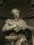 A Statue of a Person Holding an Open Book