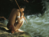 A Pinare Indian Sits by a Stream Fishing