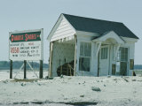 Sign Advertising a Housing Development Being Built Next to a Storm-Damaged Cottage