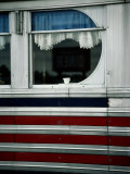 A Sign is Reflected in the Window of Local Diner