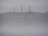 Fog Shrouds a Boat in the Early Morning