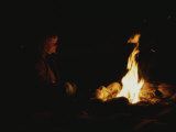Woman at a Campfire at Night