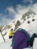 A Hiker Sets up a Tent on a Snowy Ledge on Mount Hood