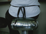 A Waitress Sits on a Shiny Stool That Reflects the Diners Interior