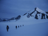 Mountain Climbers Hike Through the Snow in the St