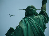 An Airplane Flies Near the Statue of Liberty