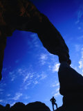 Hiker Silhouetted Beneath Delicate Arch  Arches National Park  Utah  USA