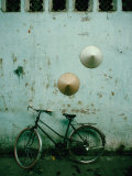 Conical Hats Hang on Wall Above Bicycle in Historic Old Quarter  Hanoi  Vietnam