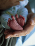 A Father Holding His Baby's Feet