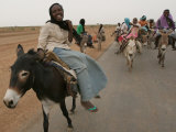 Sudanese Women Ride Donkeys at the Entrance of the Zamzam Refugee Camp