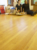Couple Having Pizza and Red Wine in Empty Apartment