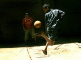 An Egyptian Boy Shows off His Ball Skill as He Plays Soccer with a Friend on the Steets of Cairo
