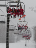 Skiers and Snowboarders Dressed as Santa Claus Ride up the Ski Lift