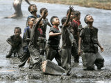 Refugee Children Try to Catch Relief Goods Tossed from an Australian Military Helicopter